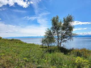 Fototapeta premium clouds and rising sun rays over lake Baikal