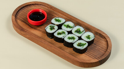 Sushi roll on wooden tray