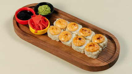 Sushi roll with soy sauce on wooden tray