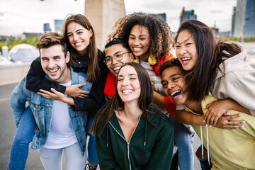 Diverse group of young friends having fun together outdoors. Youth community and friendship concept.