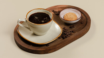 Coffee cup on wooden tray, coffee beans