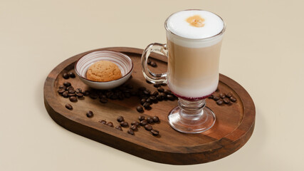 Coffee in glass cup on wooden tray, coffee beans