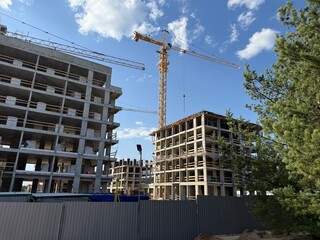 Construction site with cranes and modern buildings under development, real estate and architecture industry background