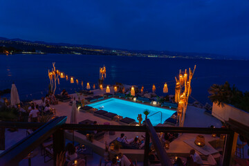 Chic seaside rooftop lounge with glowing pool, lanterns, and ocean views in Opatia Croatia