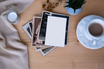 vintage Nostalgic photo album with blank space for picture on wooden table, surrounded by memories...