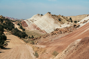 Colorful, layered hills create an abstract terrain evocative of natural art.