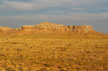 Vast golden terrain highlighting unique geological structures under the sun.
