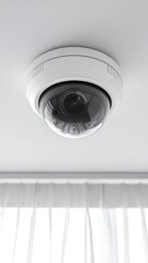 Security camera on a white ceiling with a white curtain
