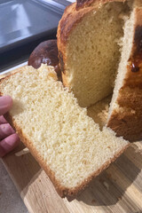 Freshly baked homemade bread cooling on a kitchen table, with a golden crust and rustic texture.