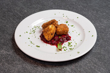 Crispy Fried Camembert Cheese with Sweet Cranberry Sauce on White Plate. Gourmet Appetizer Dish