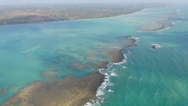 Aerial view of the coastline with reefs and turquoise water in brazil