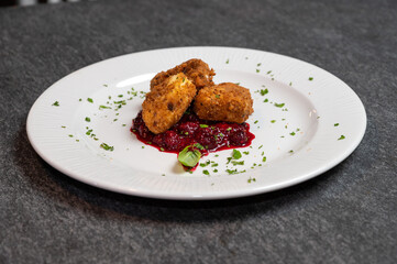 Crispy Fried Camembert Cheese with Sweet Cranberry Sauce on White Plate. Gourmet Appetizer Dish