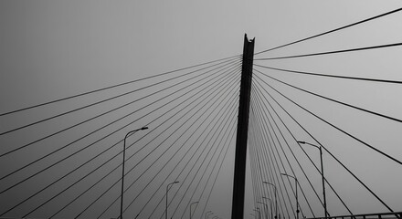 Dramatic cable-stayed bridge architecture against a vast, moody sky