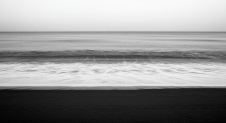 Serene black sand beach meets gentle ocean waves under a vast, minimalist sky