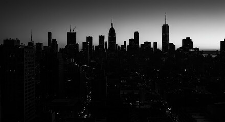 Dramatic New York City skyline silhouette at dusk, iconic skyscrapers creating a powerful urban landscape
