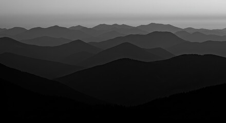 Dramatic layered mountain silhouettes at dusk evoke a sense of peace and adventure