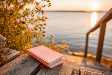 A serene moment with a book on rustic wooden steps by a shimmering lake at sunset.