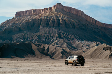 Off-Road SUV Against Subtle Textures of Impressive Mountainous Backdrop
