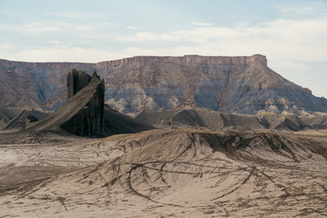 Captivating Natural Formations in Desert Landscape Overlooked by Mountain Range
