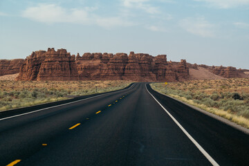 Road heading toward rugged rock formations and breathtaking scenic vistas.