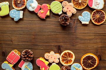 Set of different Christmas and New Year gingerbread cookies on dark wooden background, top view. Festive food concept