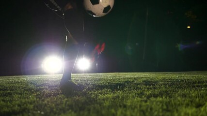 Engage in Nighttime Soccer Practice Featuring a Player Kicking a Ball on the Field - Powered by Adobe