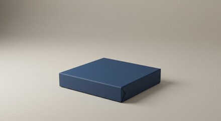 A small blue square box sits on a neutral colored surface in studio lighting.