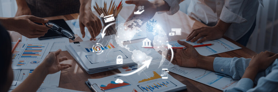 A diverse business team working together on financial charts and graphs. Digital icons signify strategies and global connections, enhancing collaborative efforts. Trope - Powered by Adobe