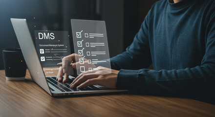 A person is using a laptop with a digital document management system interface displayed on the screen, showing tasks and checklists.