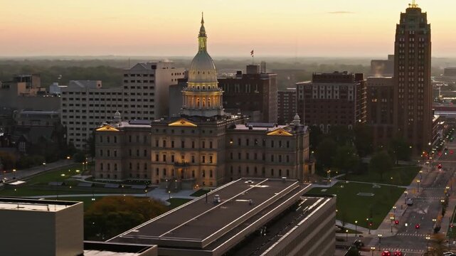 Michigan state capitol building in lansing at sunset with city skyline