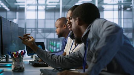 Coworker giving server hub engineer insights into developing disaster recovery plans ensuring...