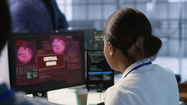 Cybersecurity experts in server farm trying to protect equipment from hacker stealing data. Close up of data center IT professionals struggling to delete virus attacking company servers, camera A