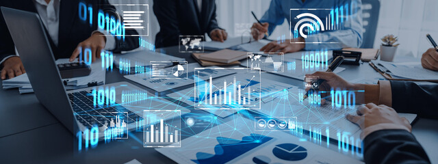 Professionals collaborate in a modern office, analyzing data and statistics while using digital technology to enhance decision-making and communication in business strategy. Trope