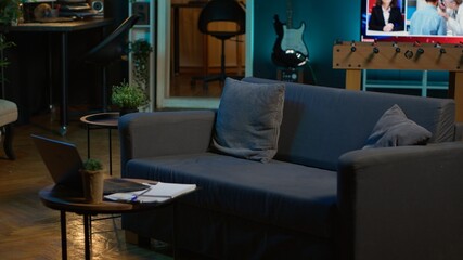 Empty contemporary studio apartment with modern decorations and equipment for a young adult, minimalist space decorated with led neon lights. Cozy urban loft with a home theatre setup.