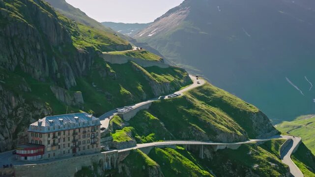 The grimsel pass road winds around a mountainside in the swiss alps