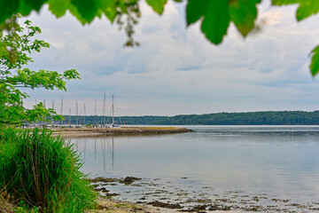 Calm bay with sailboats resting behind a narrow coastal spit at Solitude Flensburg