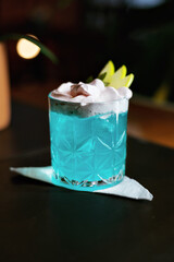 colorful fruity cocktails with decoration in a medium-sized, round glass.