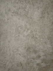 A cool ash-toned surface with a slightly rough texture and subtle markings offers a modern and industrial-chic backdrop for various product presentations