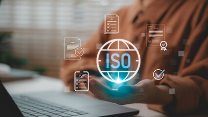 ISO certification and quality management concept with businessperson using digital platform for compliance and document approval. Suitable for standards, audit process, and corporate quality systems.