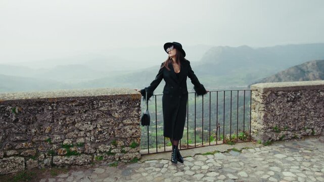 Elegant Model Posing On The Railing With A Mountain Landscape Background 