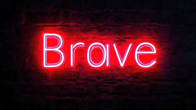 A neon sign displaying the word Brave glows brilliantly against a weathered brick wall, evoking a sense of courage and strength. The sign’s luminosity underscores resilience and valor. Stock Image.