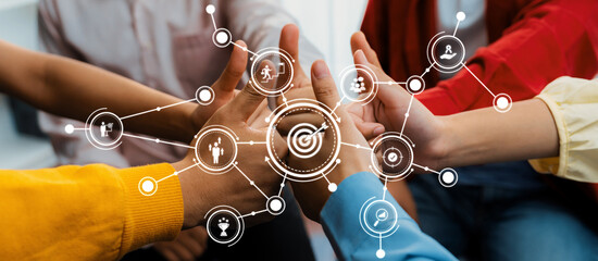 Startup company employee team stacking hand together symbolize successful group of business partnership and strong collective unity teamwork in community workplace in panoramic banner. Synergic Amity