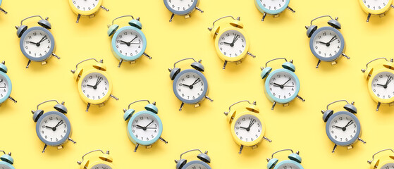 Alarm clocks on yellow background