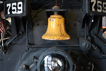 Worn Yellow Bell on Industrial Locomotive Railroad Train Background