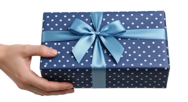 Hand presenting a blue polka dot gift box with a light blue ribbon and bow, isolated on transparent background