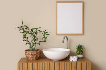 Modern sink with houseplants and towels, closeup
