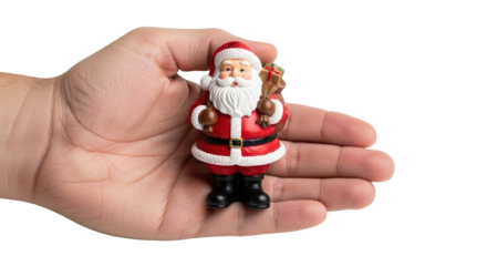 A hand holding a small santa claus figurine with a sack of gifts, isolated on a transparent background
