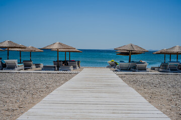 Fototapeta premium tropical beach with umbrellas and chairs