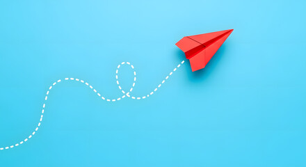 Red paper plane on blue background