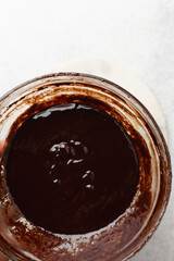 Overhead view of Dark chocolate ganache in a glass bowl